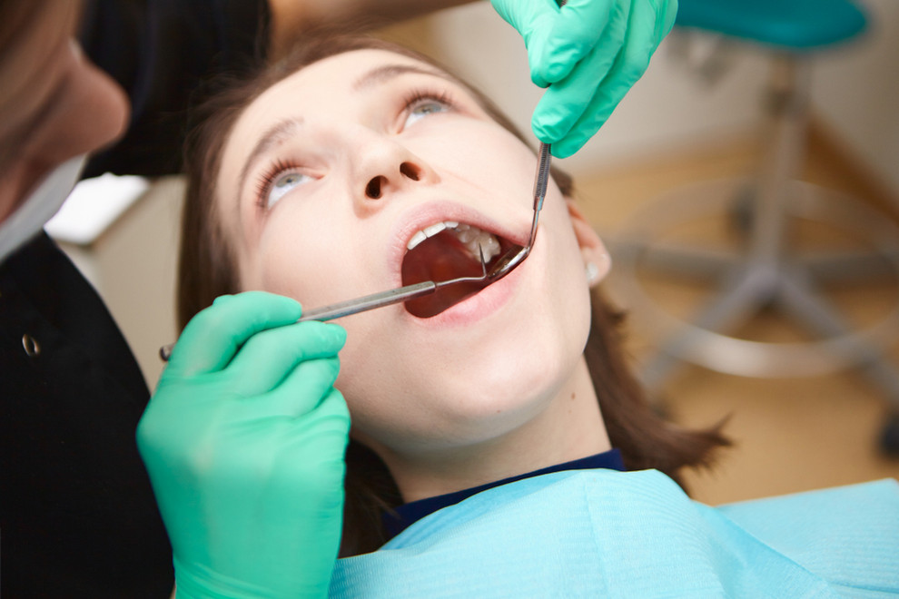 Dental hygienist checking patient for cavity