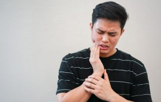 Young man experiencing pain from wisdom teeth