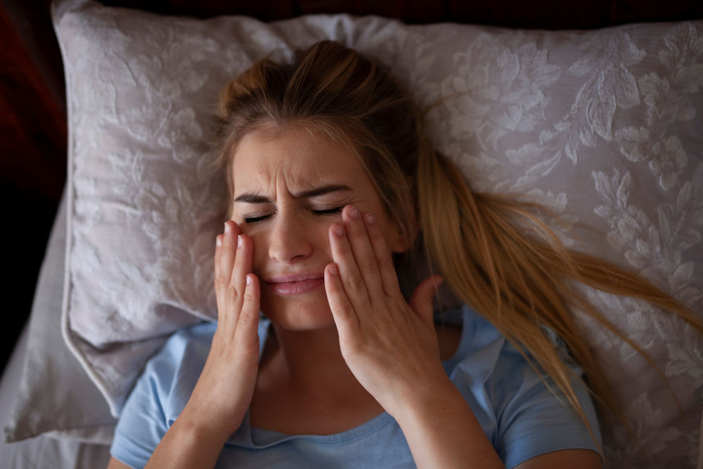 lady with dental pain from grinding