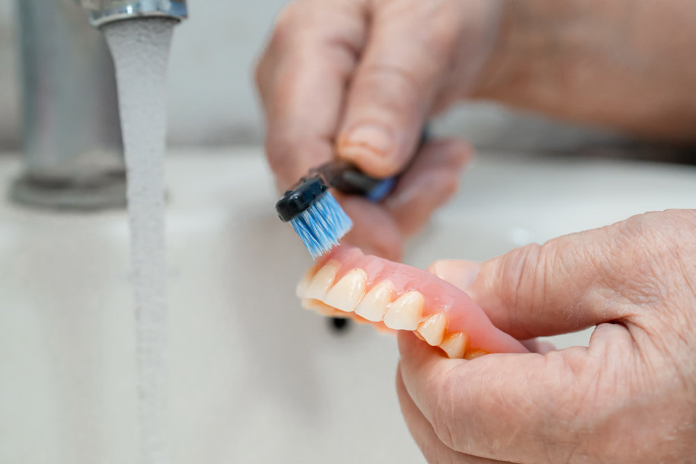 Senior washing dentures